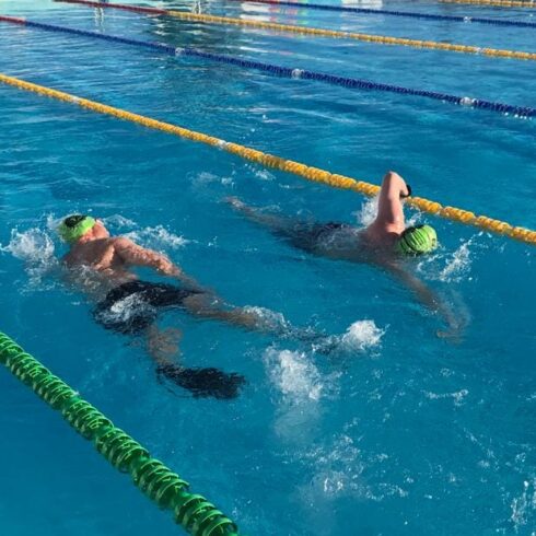 Two swimmers passing each other in a lane