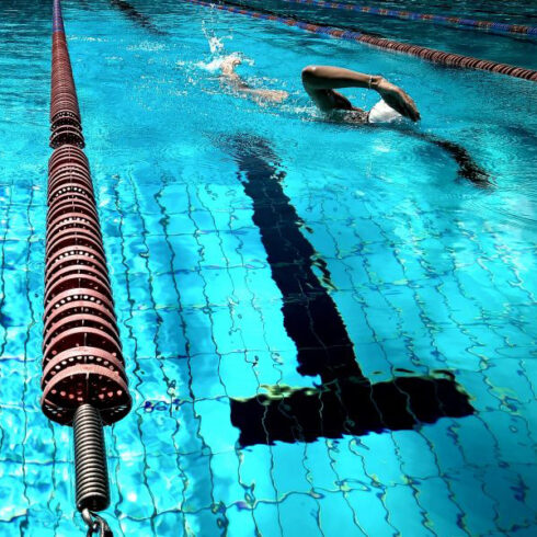 Man swimming front crawl in a pool